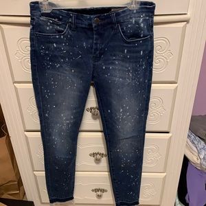 Blanknyc blue skinny jeans with white paint splatter on the legs and butt